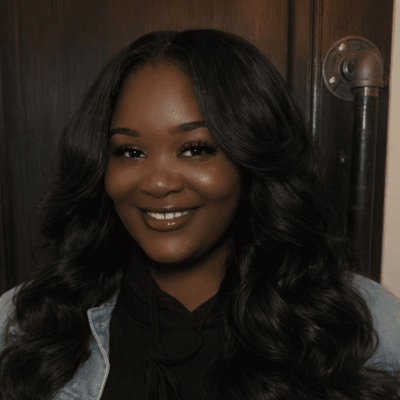 Portrait of Lysaa Chanel, a professional stylist at Noir et Blanc Salon, showcasing their expertise and style.