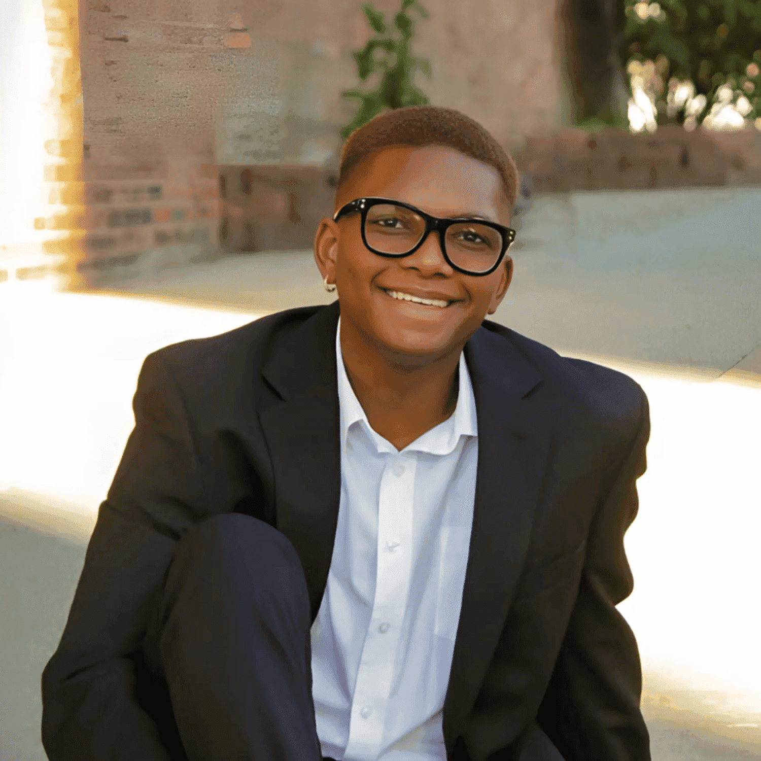 Portrait of Javon Hunter, a professional stylist at Noir et Blanc Salon, showcasing their expertise and style.