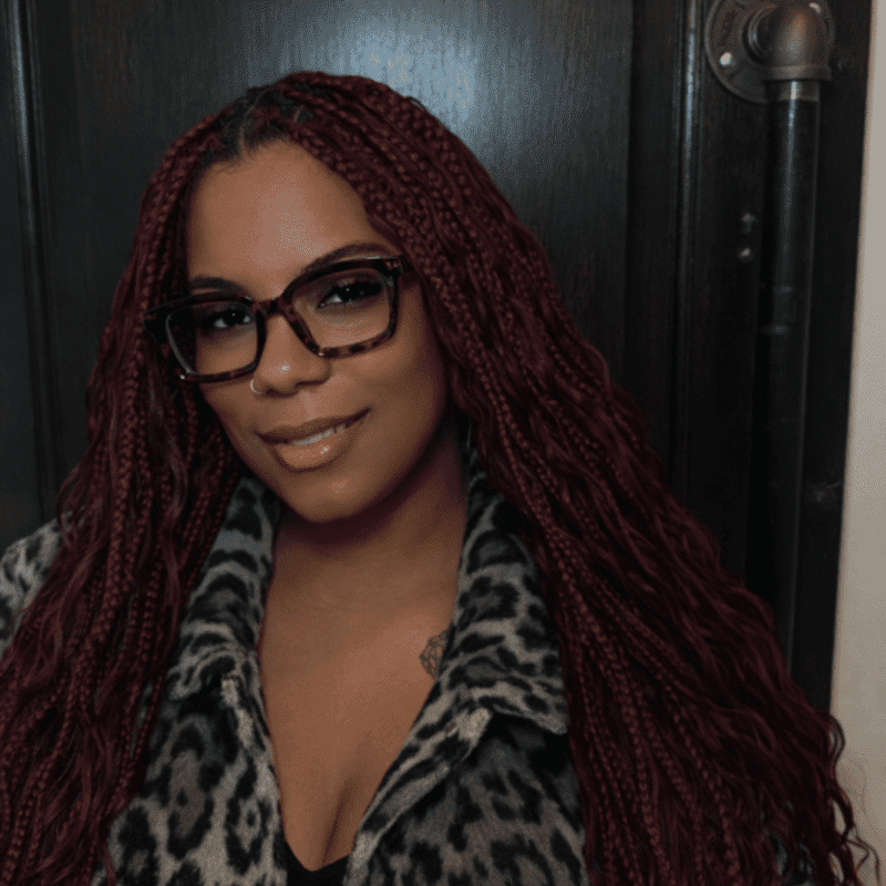 Portrait of Aliyah Stallworth, a professional stylist at Noir et Blanc Salon, showcasing their expertise and style.